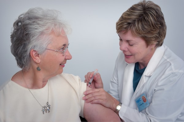 Professional caregiver assisting an elderly client at home for a Florida home care agency